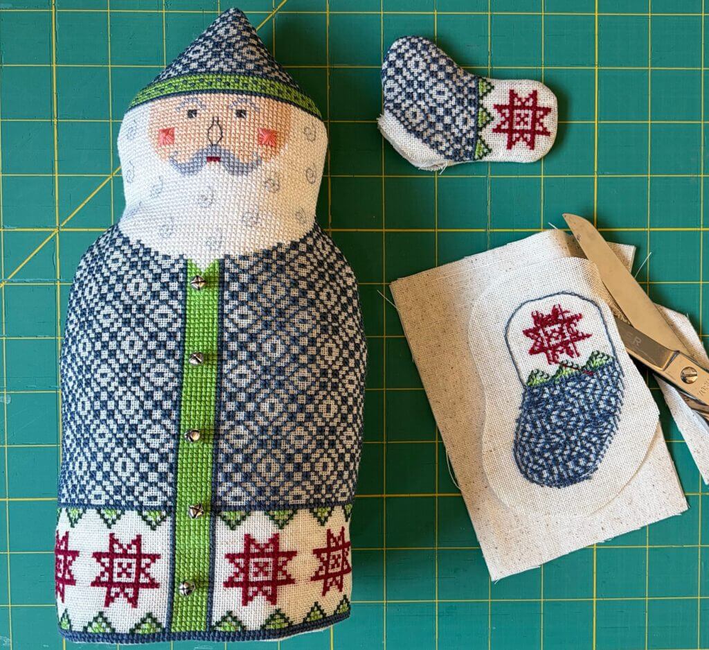 Body and arms turned, stuffed, with bells on coat