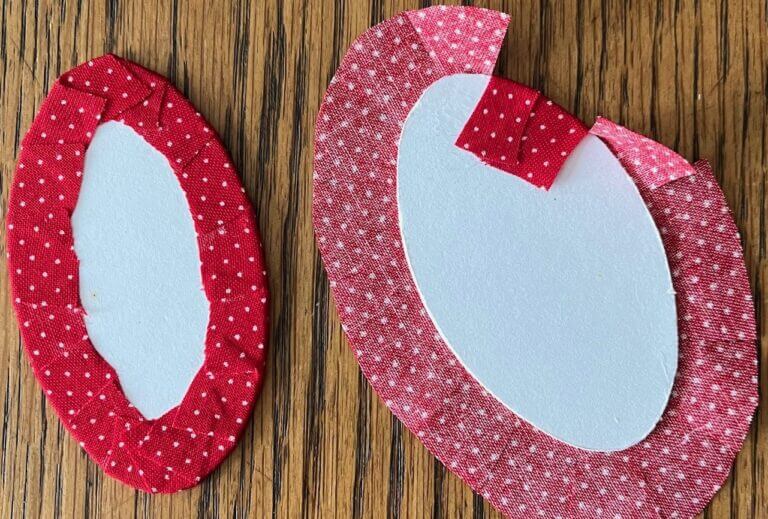 Fabric being glued to doll bases