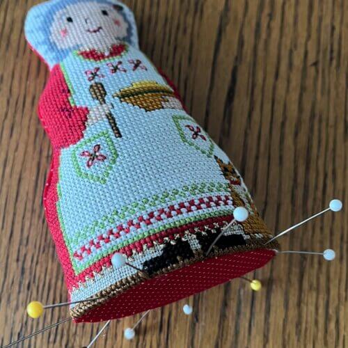 Doll with pins in base